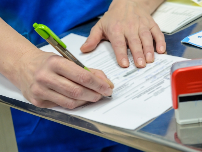 hands on paper writing with a pen