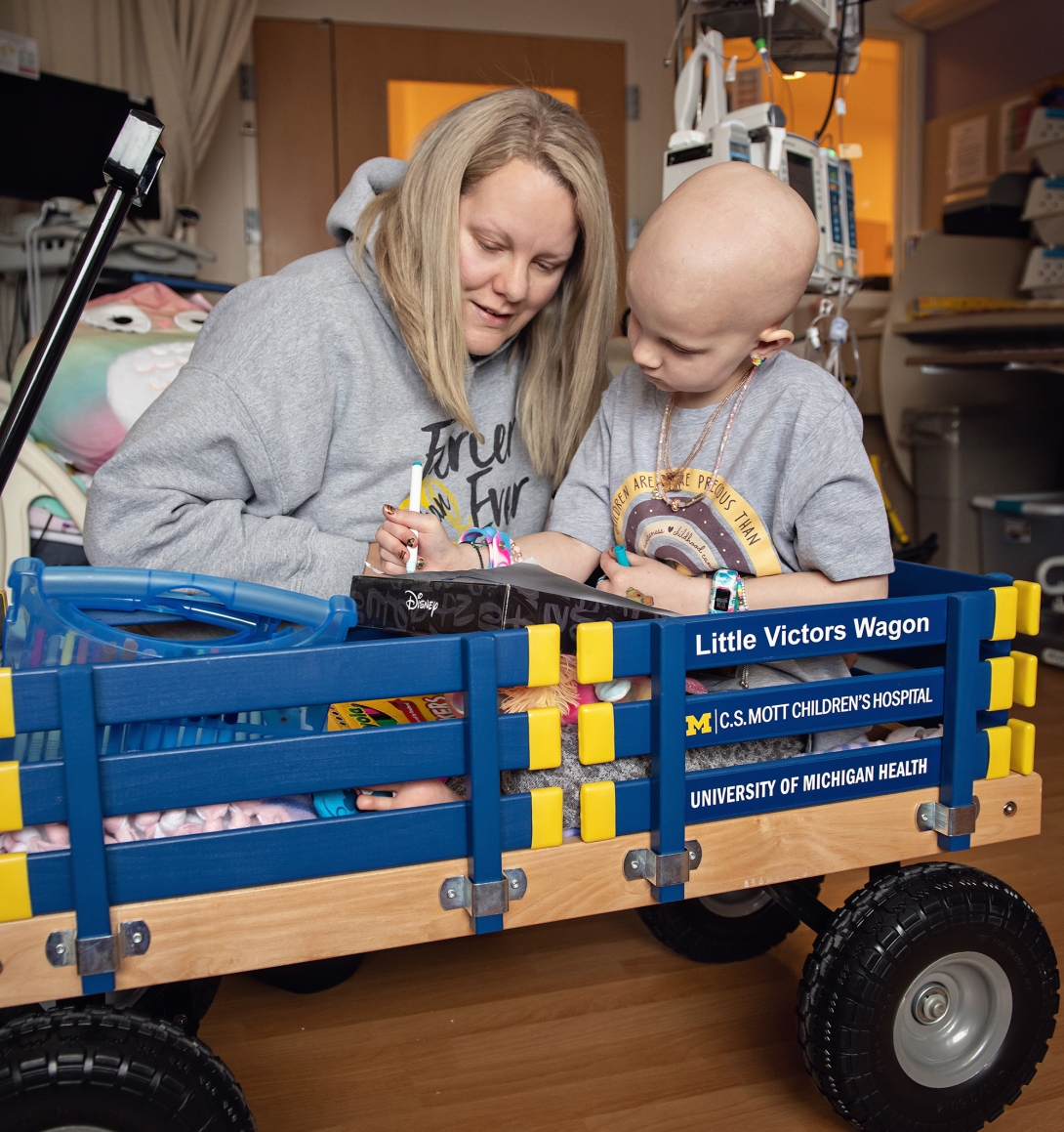 Mott patient sitting in little victors wagon